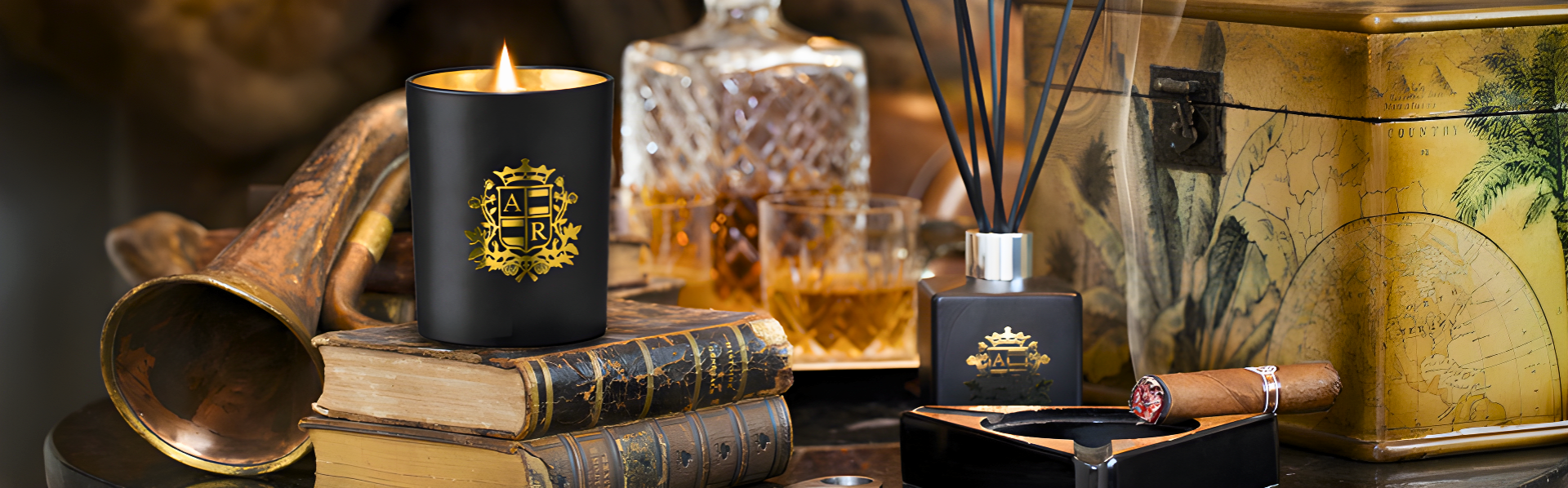 Candle with decorative packaging on a table with books and other items