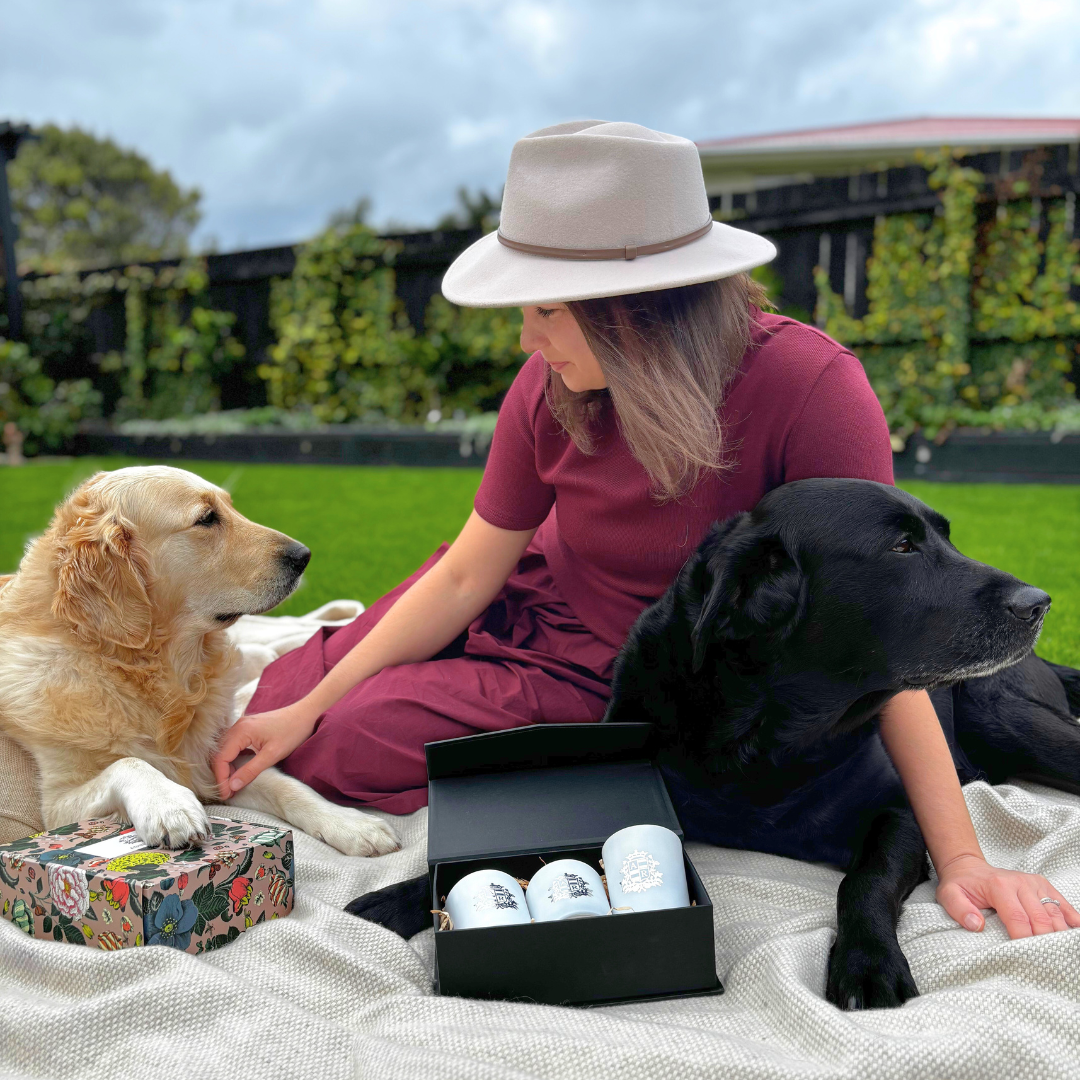 Lady sitting with her tow dogs showcasing Abbey Rose Gift Boxes