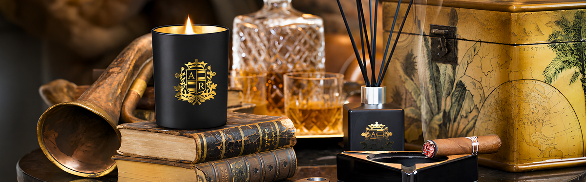 Candle with decorative packaging on a table with books and other items